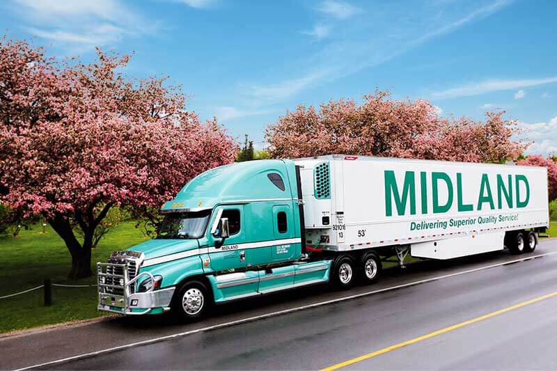 View of a transport truck with a branded Midland trailer
